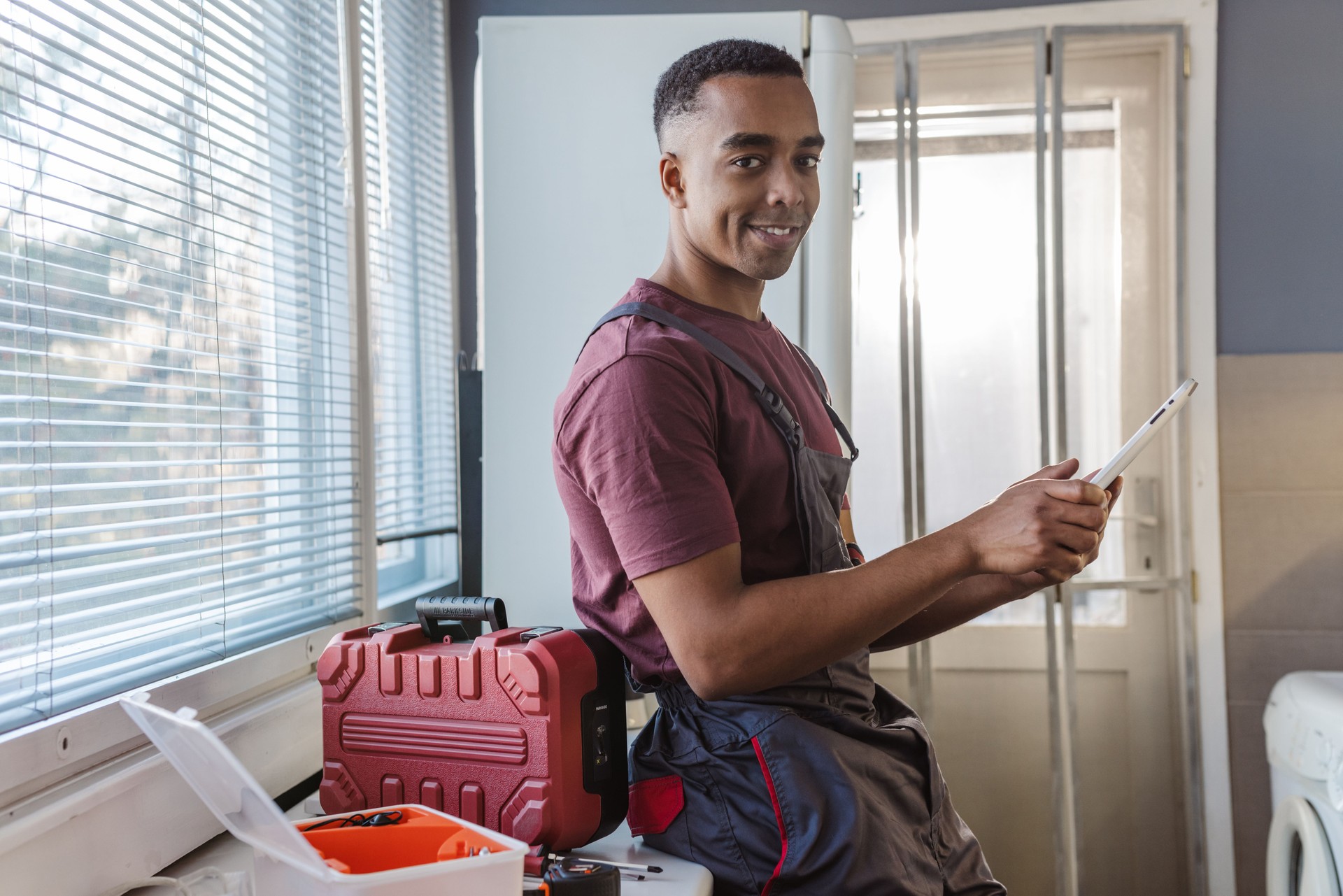 Portrait of African American handyman using digital tablet